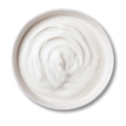 White cream in a round container on a white background