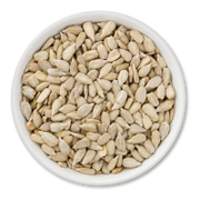 White bowl filled with sunflower seeds on a white background