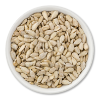 White bowl filled with sunflower seeds on a white background